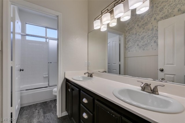 1453 Doggett Ave, Las Vegas, NV 89123 - bathroom with a wainscoted wall, double vanity, combined bath / shower with glass door, and wallpapered walls