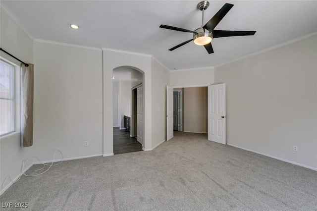 1453 Doggett Ave, Las Vegas, NV 89123 - empty room with crown molding, arched walkways, carpet flooring, and a ceiling fan