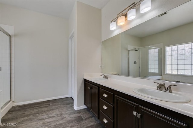 1453 Doggett Ave, Las Vegas, NV 89123 - bathroom with wood finished floors, a stall shower, and double vanity