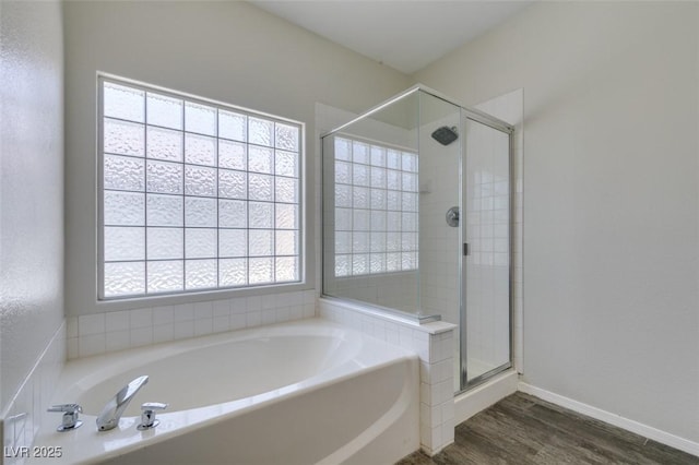 1453 Doggett Ave, Las Vegas, NV 89123 - bathroom with a bath, a shower stall, and wood finished floors