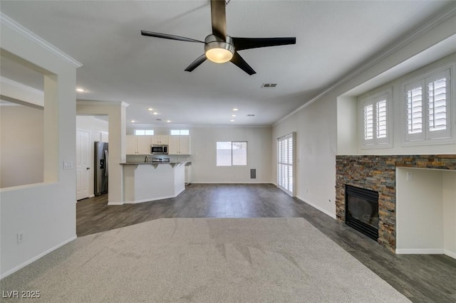 1453 Doggett Ave, Las Vegas, NV 89123 - unfurnished living room featuring crown molding, a ceiling fan, dark wood-type flooring, recessed lighting, and a stone fireplace