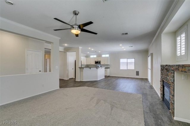 1453 Doggett Ave, Las Vegas, NV 89123 - unfurnished living room with ornamental molding, a fireplace, ceiling fan, recessed lighting, and dark wood-style floors