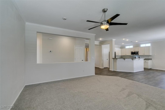 1453 Doggett Ave, Las Vegas, NV 89123 - unfurnished living room featuring dark colored carpet, crown molding, a ceiling fan, and recessed lighting
