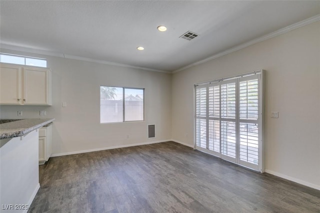 1453 Doggett Ave, Las Vegas, NV 89123 - kitchen with dark wood-type flooring, white cabinetry, ornamental molding, recessed lighting, and light stone countertops