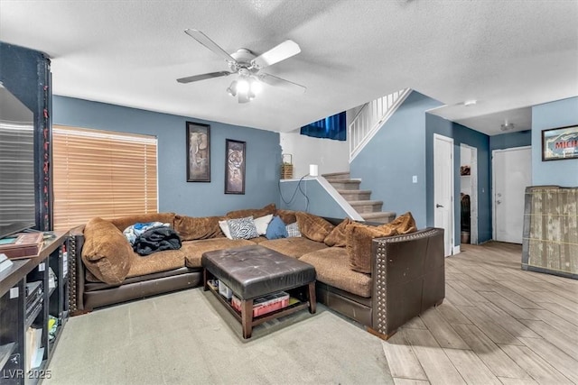 5612 Royal Castle Ln, Las Vegas, NV 89130 - living area featuring wood finished floors, a ceiling fan, stairs, and a textured ceiling