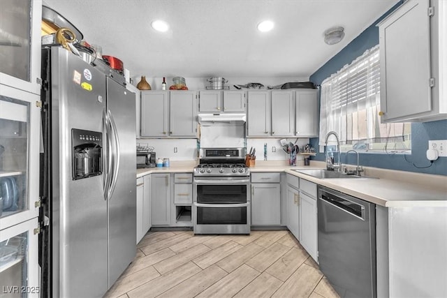 5612 Royal Castle Ln, Las Vegas, NV 89130 - kitchen featuring stainless steel appliances, under cabinet range hood, recessed lighting, light countertops, and wood tiled floors