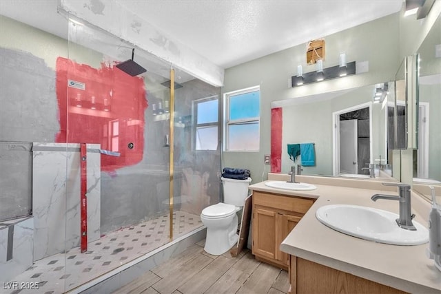 5612 Royal Castle Ln, Las Vegas, NV 89130 - bathroom featuring a marble finish shower, double vanity, beam ceiling, and wood finished floors