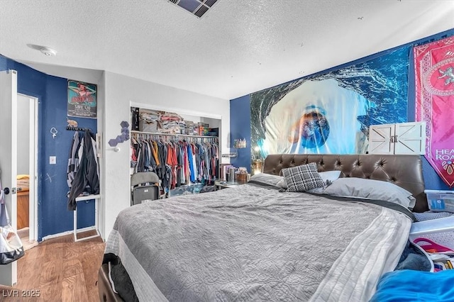 5612 Royal Castle Ln, Las Vegas, NV 89130 - bedroom featuring a textured ceiling, wood finished floors, and a closet