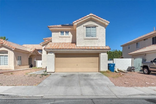 5612 Royal Castle Ln, Las Vegas, NV 89130 - mediterranean / spanish house with a tiled roof, stucco siding, roof mounted solar panels, and concrete driveway