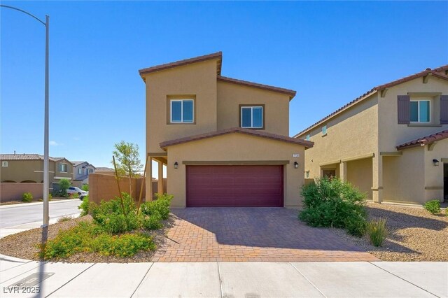 7730 Moore Creek Ln, North Las Vegas, NV 89084 - view of front of house featuring stucco siding, a garage, driveway, and a residential view