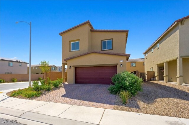 7730 Moore Creek Ln, North Las Vegas, NV 89084 - view of front of property with a garage, stucco siding, and decorative driveway
