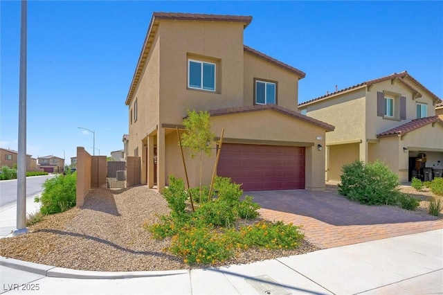 7730 Moore Creek Ln, North Las Vegas, NV 89084 - view of front facade with a garage, stucco siding, driveway, and a tile roof