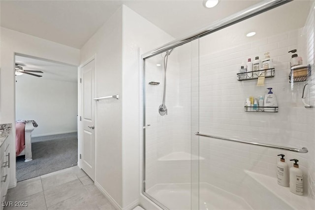 7730 Moore Creek Ln, North Las Vegas, NV 89084 - bathroom with a stall shower, ceiling fan, tile patterned floors, and vanity