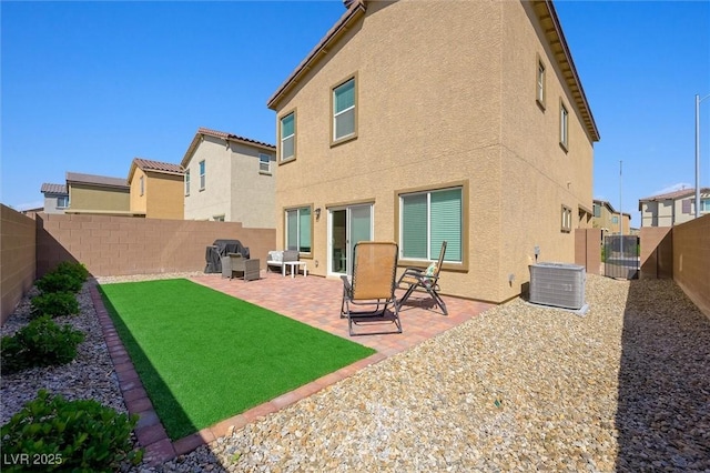 7730 Moore Creek Ln, North Las Vegas, NV 89084 - back of property featuring stucco siding, a fenced backyard, and a patio