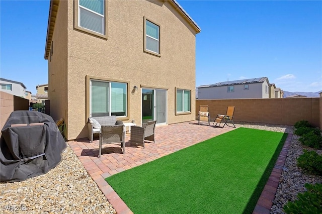 7730 Moore Creek Ln, North Las Vegas, NV 89084 - back of house with stucco siding, a fenced backyard, and a patio