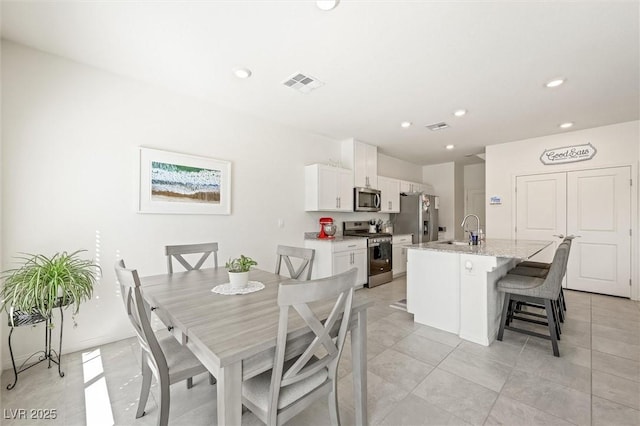 7730 Moore Creek Ln, North Las Vegas, NV 89084 - dining space with recessed lighting and light tile patterned floors