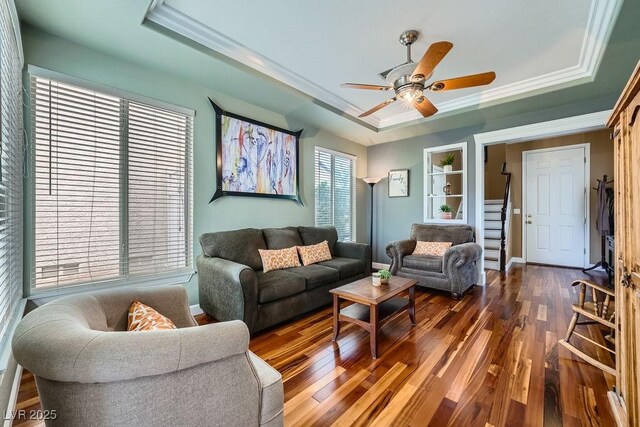 6125 Broken Slate Way, Las Vegas, NV 89139 - living area featuring a raised ceiling, crown molding, a ceiling fan, wood finished floors, and stairway