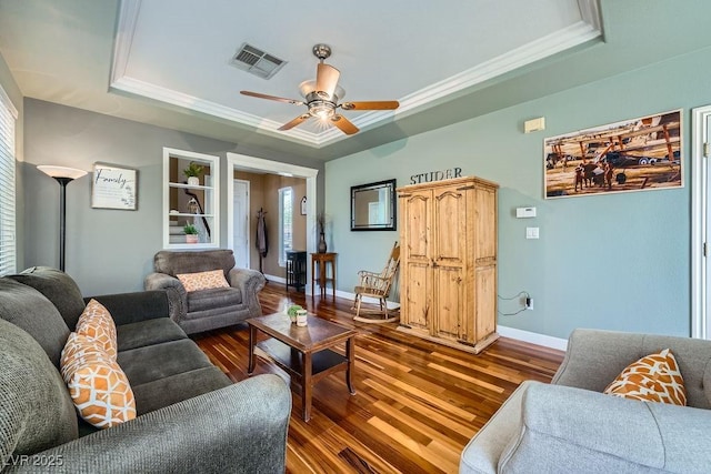 6125 Broken Slate Way, Las Vegas, NV 89139 - living area featuring a raised ceiling, wood finished floors, ceiling fan, and ornamental molding