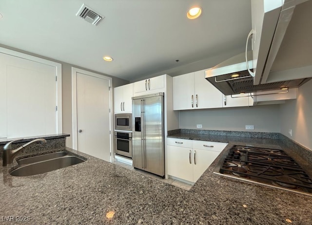 4525 Dean Martin Dr Unit 2704, Las Vegas, NV 89103 - kitchen featuring built in appliances, white cabinetry, dark stone countertops, and recessed lighting