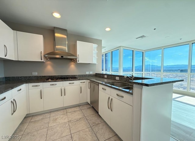 4525 Dean Martin Dr Unit 2704, Las Vegas, NV 89103 - kitchen featuring wall chimney exhaust hood, dishwasher, a peninsula, white cabinets, and recessed lighting
