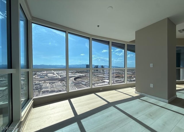4525 Dean Martin Dr Unit 2704, Las Vegas, NV 89103 - unfurnished sunroom featuring a view of city and a mountain view