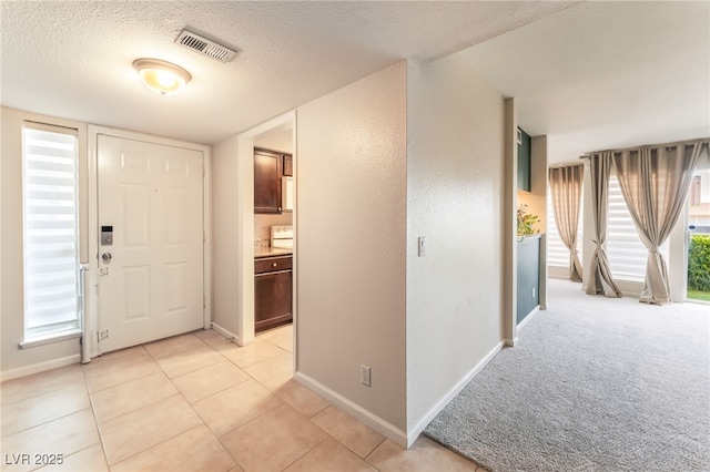 2866 Loveland Dr Unit 2018, Las Vegas, NV 89109 - foyer featuring a textured ceiling and light tile patterned flooring