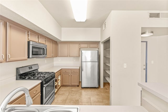 4830 Grey Wolf Ln Unit 104, Las Vegas, NV 89149 - kitchen featuring appliances with stainless steel finishes, light countertops, and light tile patterned floors