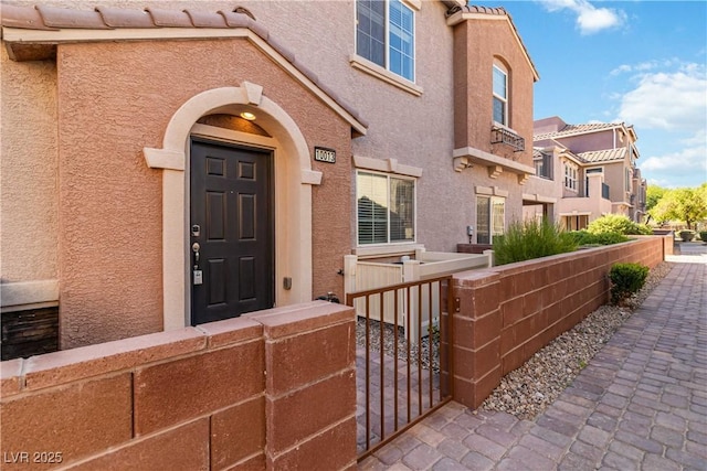 10013 Sable Point St, Las Vegas, NV 89178 - doorway to property with stucco siding, a gate, and a residential view