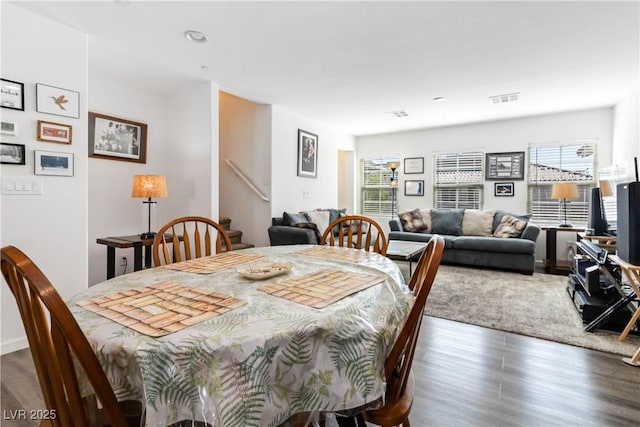 10013 Sable Point St, Las Vegas, NV 89178 - dining space with healthy amount of natural light, wood finished floors, stairway, and recessed lighting