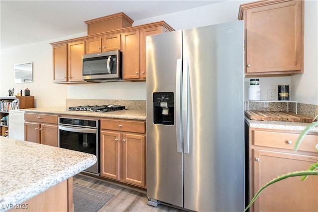 10013 Sable Point St, Las Vegas, NV 89178 - kitchen featuring stainless steel appliances, light wood-type flooring, and light countertops