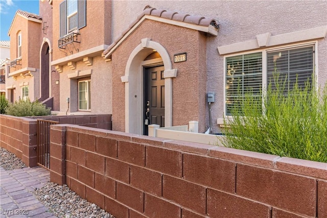10013 Sable Point St, Las Vegas, NV 89178 - view of exterior entry featuring stucco siding and a tile roof
