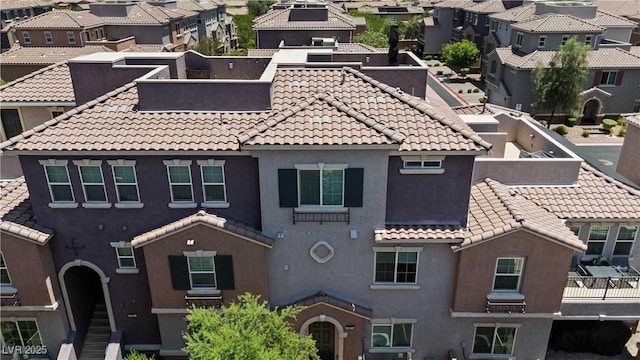 10013 Sable Point St, Las Vegas, NV 89178 - view of front facade featuring a residential view, a tiled roof, and stucco siding