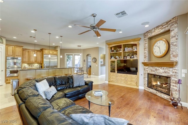 2008 Winter Wind St, Las Vegas, NV 89134 - living area with ceiling fan, a fireplace, recessed lighting, and light wood-style flooring