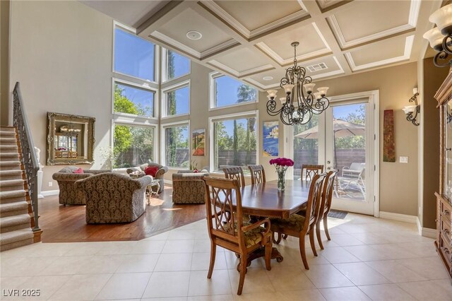 2008 Winter Wind St, Las Vegas, NV 89134 - dining room featuring healthy amount of natural light, a chandelier, coffered ceiling, stairs, and light tile patterned floors