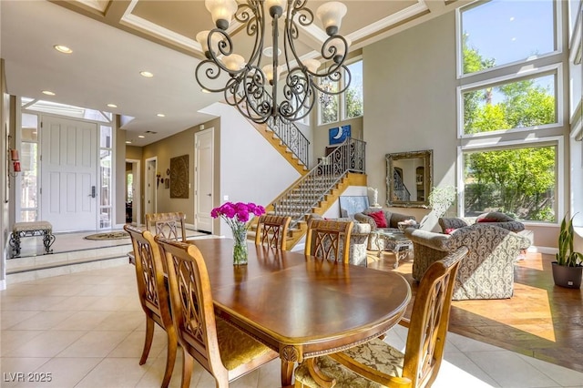 2008 Winter Wind St, Las Vegas, NV 89134 - dining space with light tile patterned floors, a chandelier, a towering ceiling, stairs, and recessed lighting