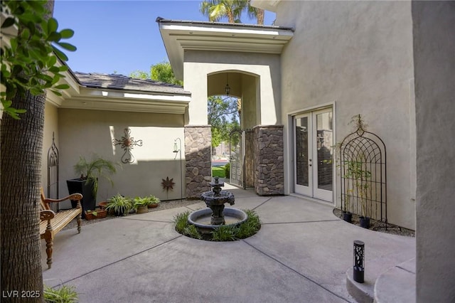 2008 Winter Wind St, Las Vegas, NV 89134 - doorway to property featuring french doors, a patio area, and stucco siding