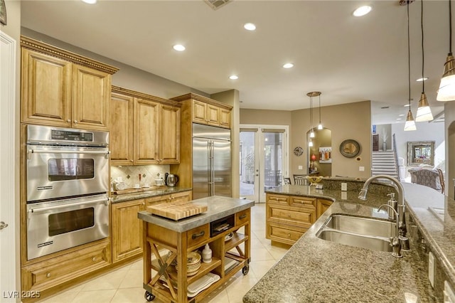 2008 Winter Wind St, Las Vegas, NV 89134 - kitchen featuring stainless steel appliances, recessed lighting, light tile patterned flooring, backsplash, and pendant lighting