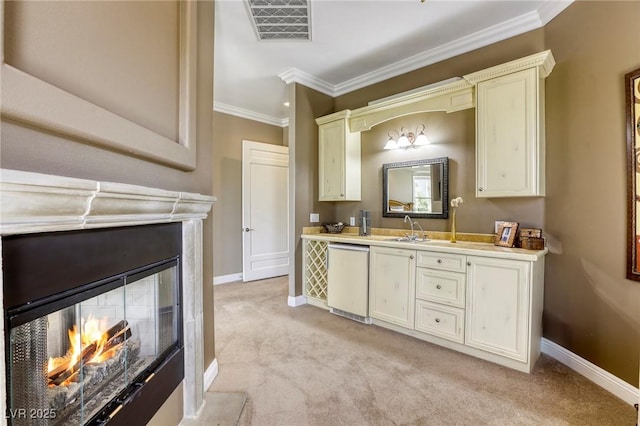 2008 Winter Wind St, Las Vegas, NV 89134 - kitchen featuring a multi sided fireplace, light carpet, light countertops, ornamental molding, and white dishwasher