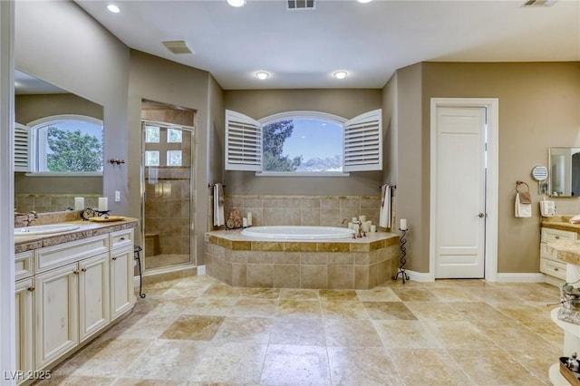 2008 Winter Wind St, Las Vegas, NV 89134 - full bathroom featuring vanity, a bath, healthy amount of natural light, a stall shower, and recessed lighting