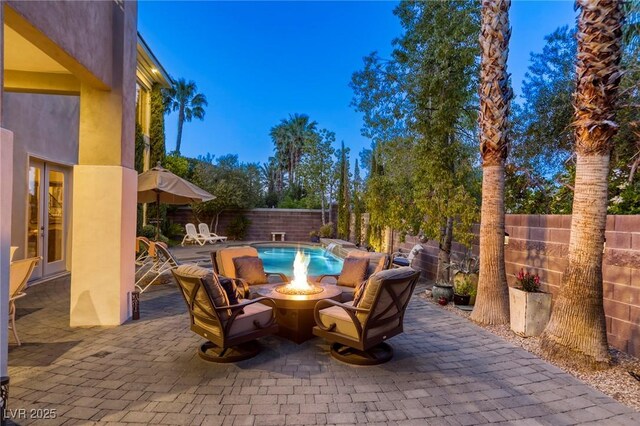 2008 Winter Wind St, Las Vegas, NV 89134 - fenced backyard with a fire pit, french doors, and a patio area