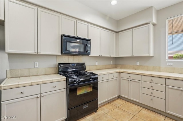 3609 Kingfishers Catch Ave, North Las Vegas, NV 89084 - kitchen featuring black appliances, light tile patterned flooring, recessed lighting, and tile countertops