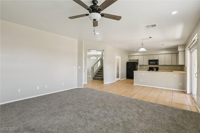 3609 Kingfishers Catch Ave, North Las Vegas, NV 89084 - unfurnished living room featuring light tile patterned flooring, a ceiling fan, light carpet, recessed lighting, and stairway