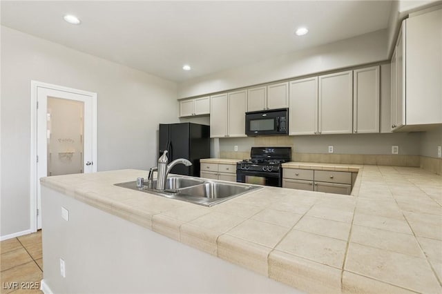3609 Kingfishers Catch Ave, North Las Vegas, NV 89084 - kitchen featuring black appliances, tile countertops, light tile patterned flooring, and recessed lighting