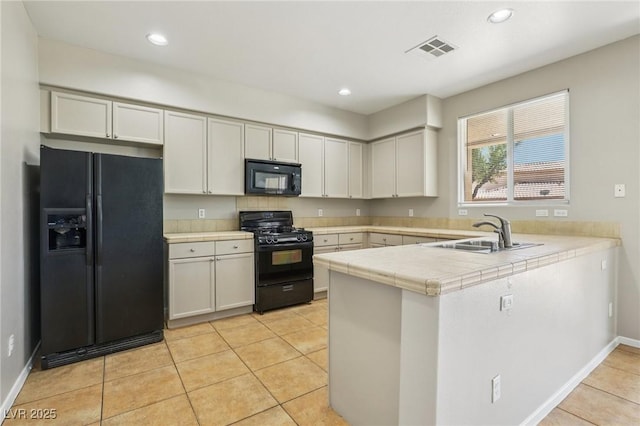 3609 Kingfishers Catch Ave, North Las Vegas, NV 89084 - kitchen featuring black appliances, a peninsula, light tile patterned flooring, recessed lighting, and tile counters