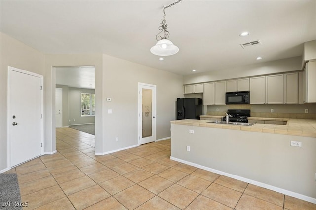 3609 Kingfishers Catch Ave, North Las Vegas, NV 89084 - kitchen with black appliances, tile countertops, a peninsula, light tile patterned floors, and pendant lighting