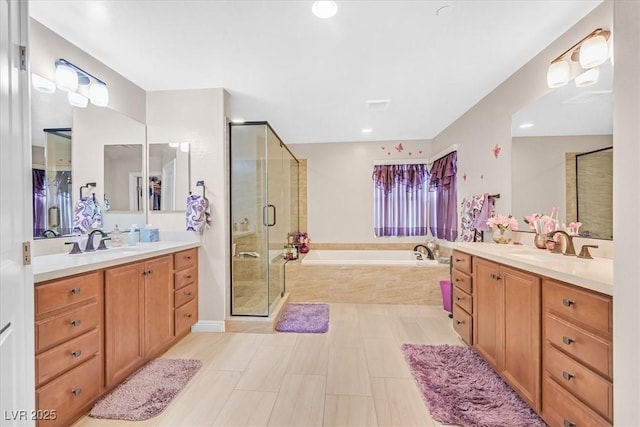 2194 Trivero St, Henderson, NV 89044 - bathroom featuring two vanities, a bath, a stall shower, and recessed lighting