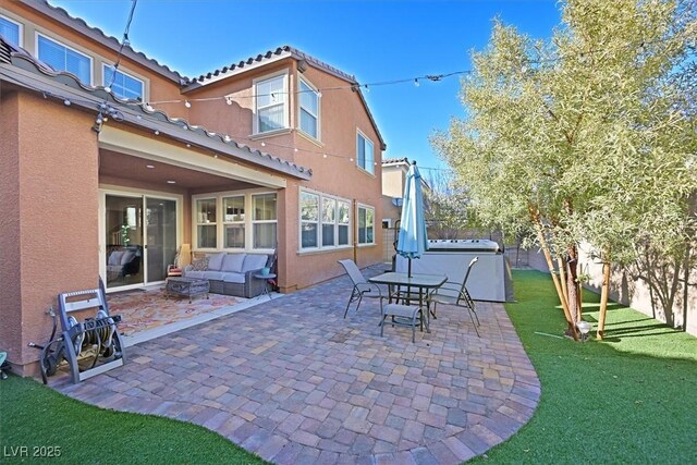 2194 Trivero St, Henderson, NV 89044 - fenced backyard featuring a patio, an outdoor hangout area, and a hot tub