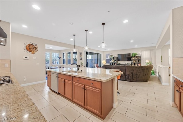2194 Trivero St, Henderson, NV 89044 - kitchen with stainless steel appliances, brown cabinets, light stone countertops, healthy amount of natural light, and recessed lighting