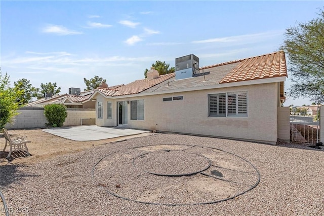6209 Lenaking Ave, Las Vegas, NV 89122 - back of property with a fenced backyard, a patio, a tile roof, and stucco siding