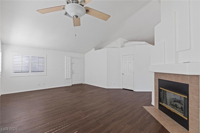 6209 Lenaking Ave, Las Vegas, NV 89122 - unfurnished living room featuring lofted ceiling, dark wood finished floors, a tiled fireplace, and a ceiling fan
